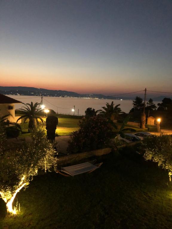 a view of a lake at night with lights at Aloni Studios and Apartments in Lassi