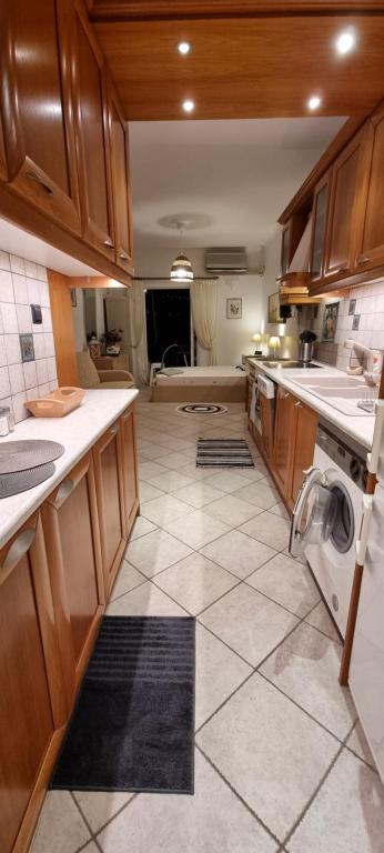 a large kitchen with a washer and dryer in it at Beautiful Seaside Studio in Akrata