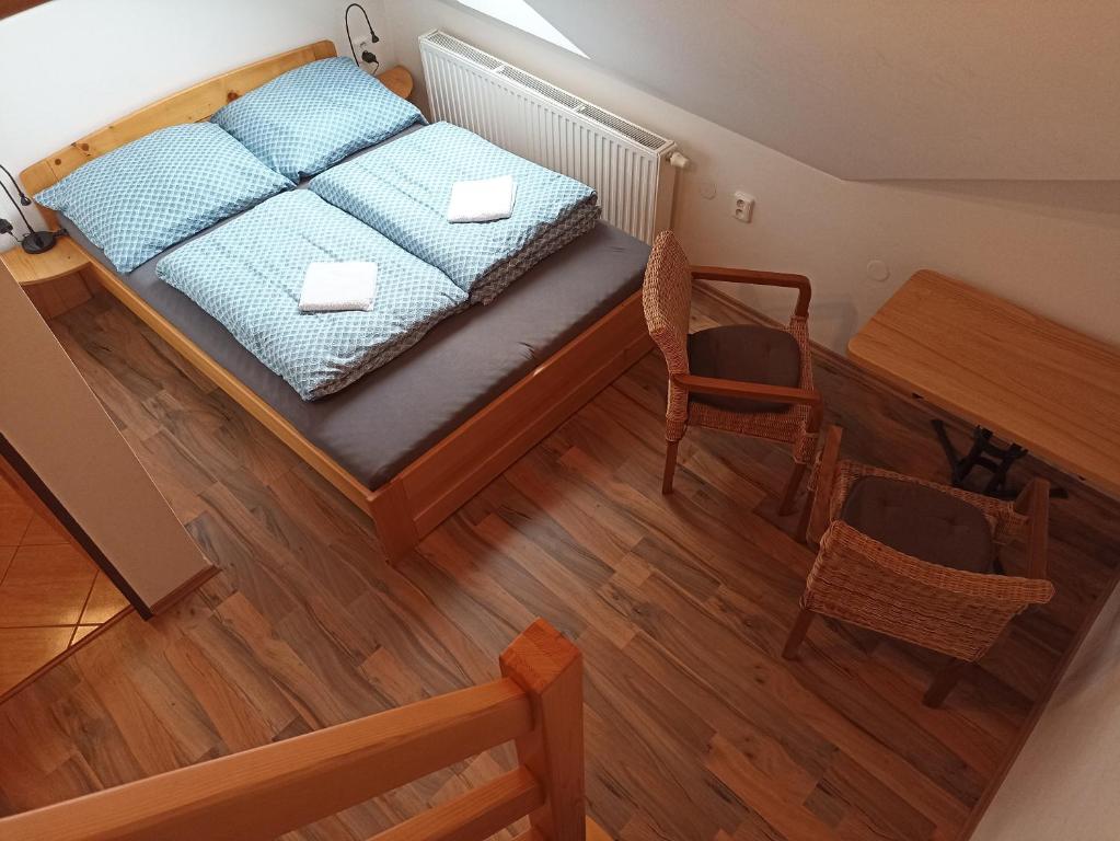 an overhead view of a bedroom with a bed and a table at Penzion U Bušů in Malá Bystřice