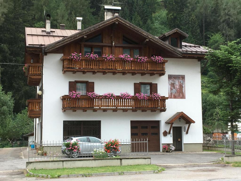 a house with a balcony with flowers on it at Appartamento Cogolo con terrazza in Cogolo