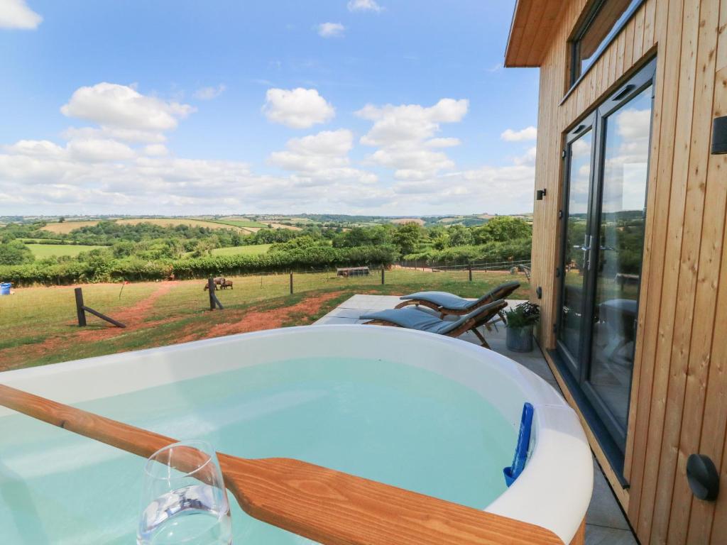 a jacuzzi tub with a view of the countryside at The Bickleigh in Tiverton