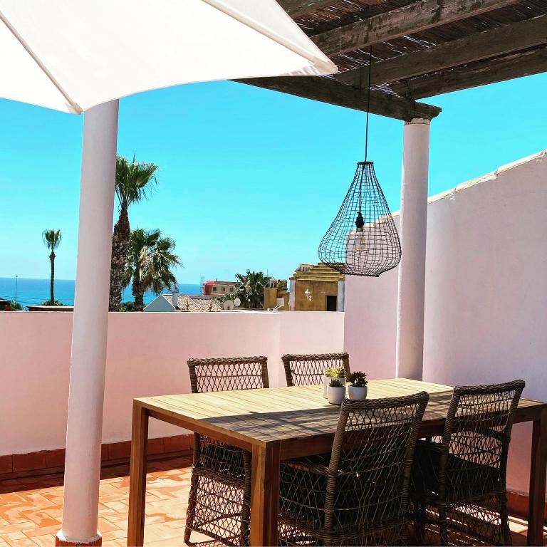 stół i krzesła na tarasie z widokiem na ocean w obiekcie Casa La Mata w mieście Torrevieja