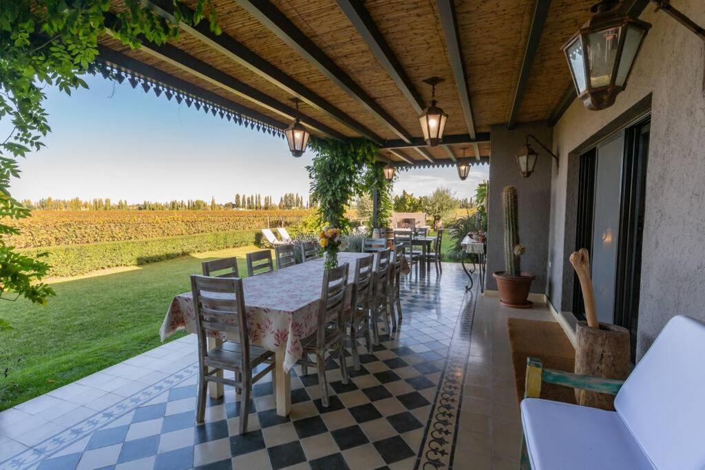 a patio with a table and chairs on a porch at Durigutti Family Winemakers - Casas de Huéspedes in Las Compuertas