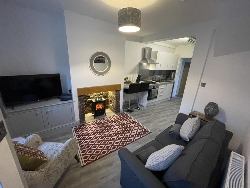 a living room with a couch and a fireplace at Two bed holiday home in Conwy in Conwy