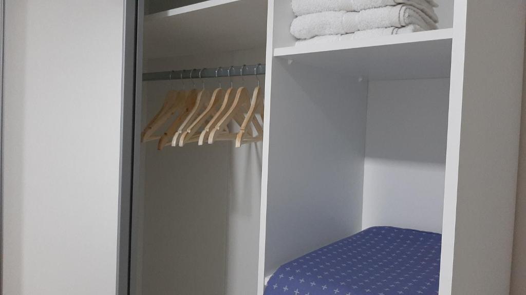 a walk in closet with towels on a shelf at Apartman 222 in Brčko