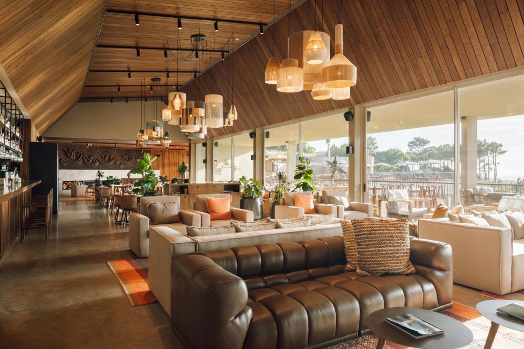 a living room with a couch and chairs at Immerso Hotel, a Member of Design Hotels in Ericeira