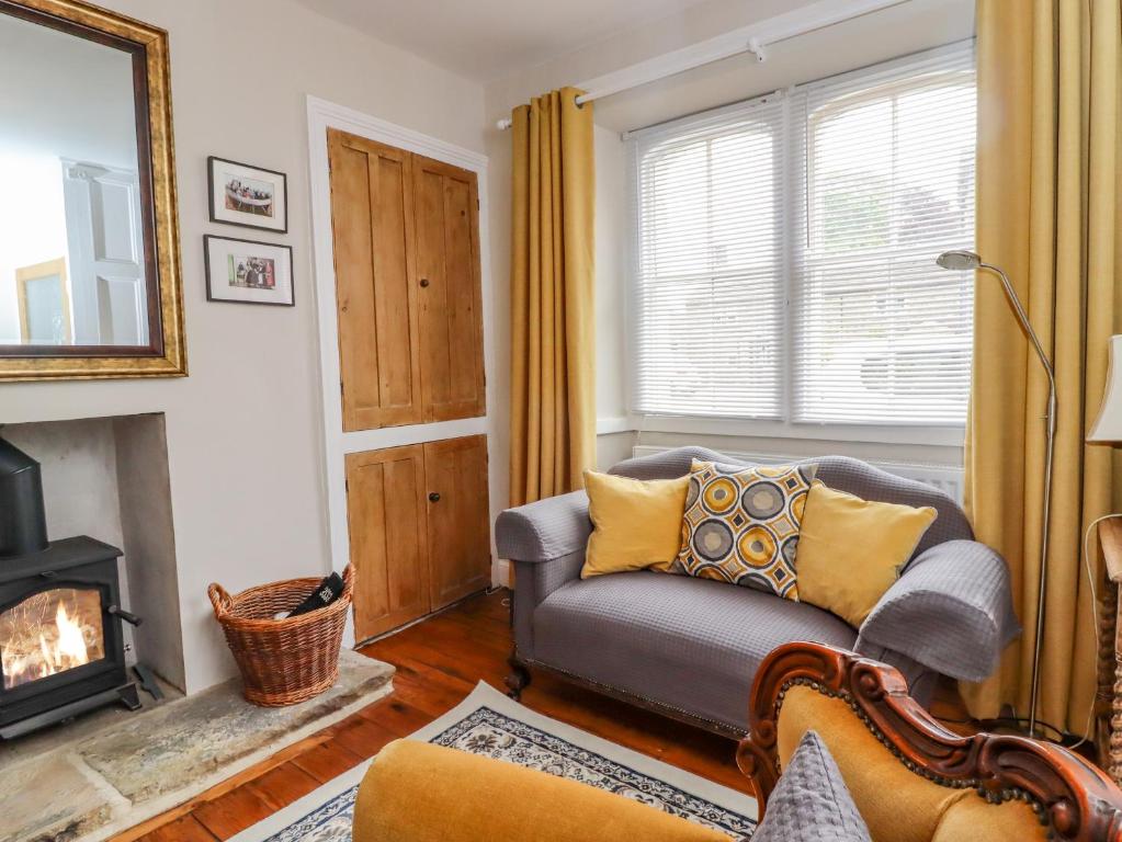 a living room with a couch and a fireplace at 5 East Street in Skipton