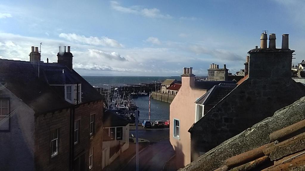 a view of a city with buildings and the ocean at Anchor House in Pittenweem