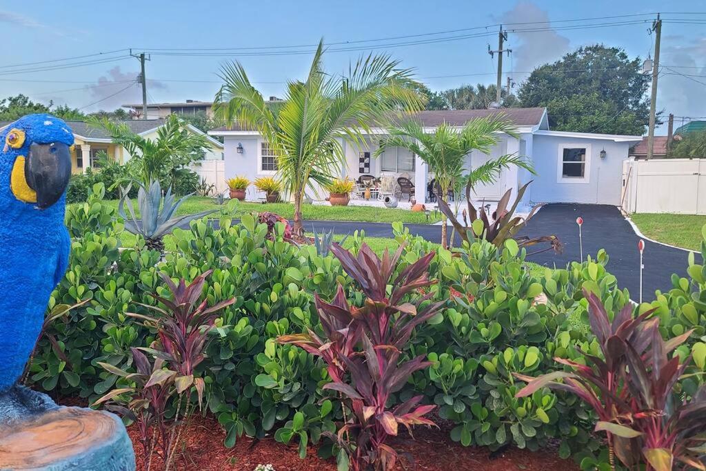 a blue bird statue in front of a house at Palm Springs 3-Bedroom 2-Bath 5 Miles to the Beach in Lake Worth