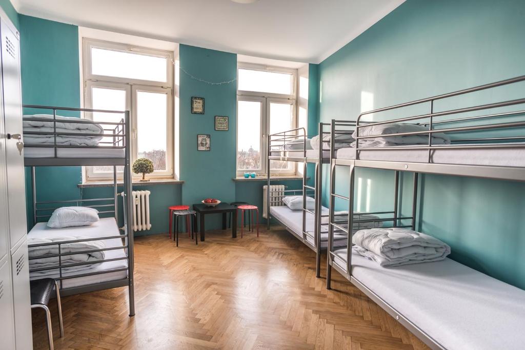 a room with three bunk beds in it at Bubble Hostel in Krakow