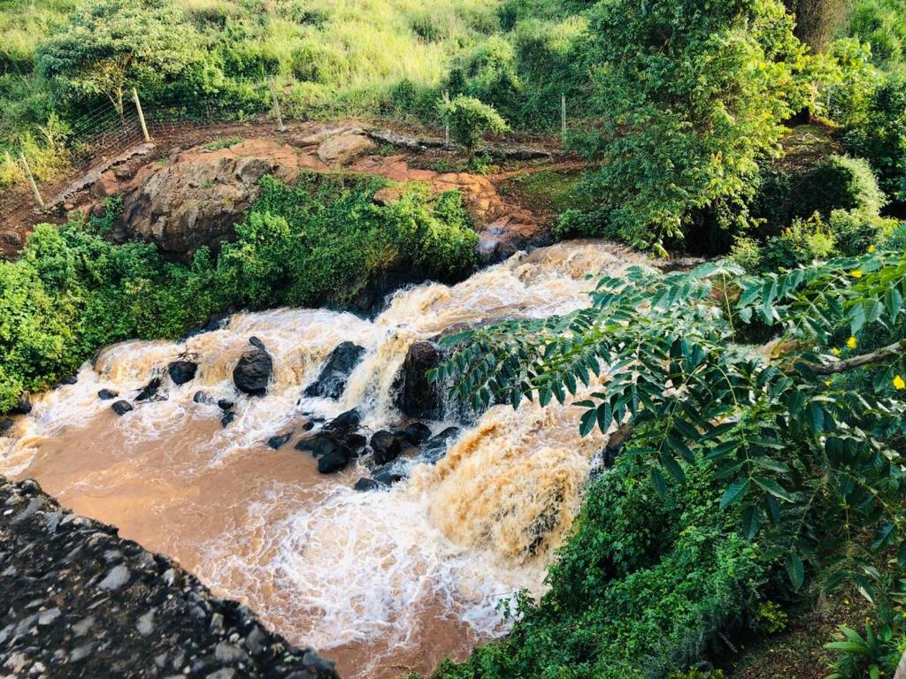 an aerial view of a river with a waterfall at Villa Rock Stop Falls Gigiri in Nairobi