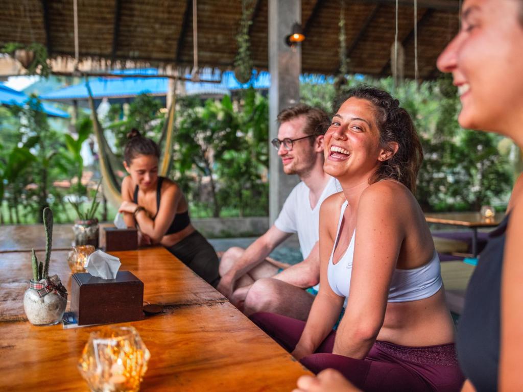 a group of people sitting at a table at Wonderland Healing Center in Thongsala