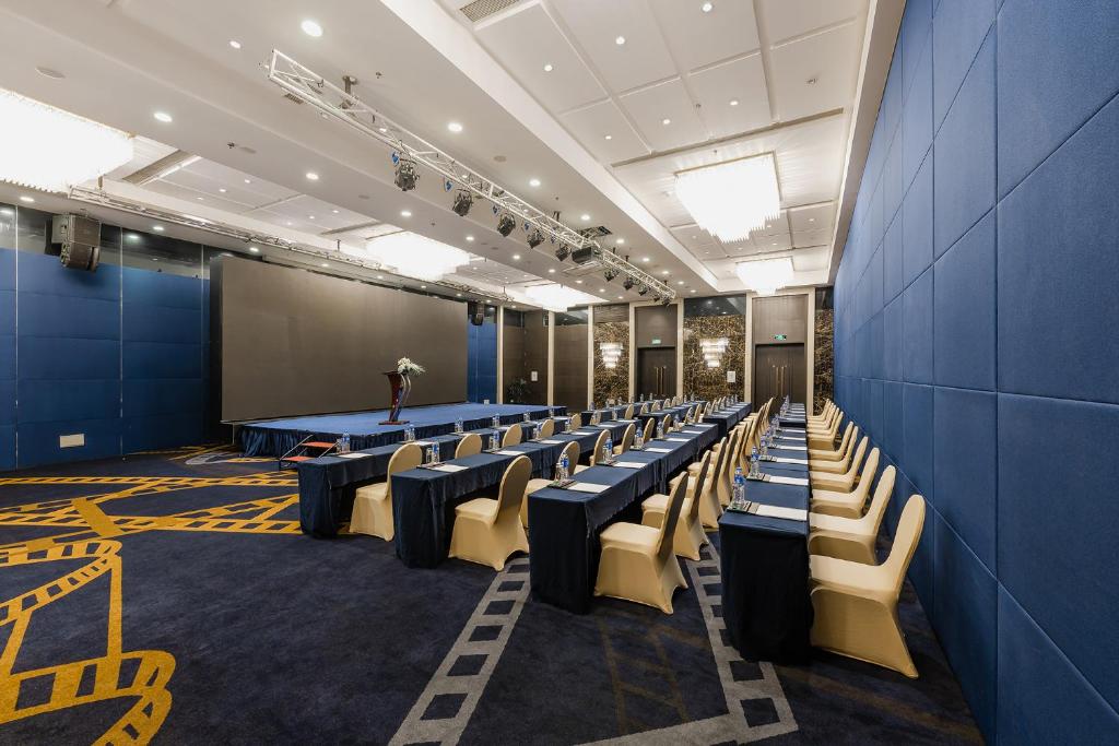 a conference room with chairs and a podium in the middle at Crowne Plaza Shanghai by IHG in Shanghai