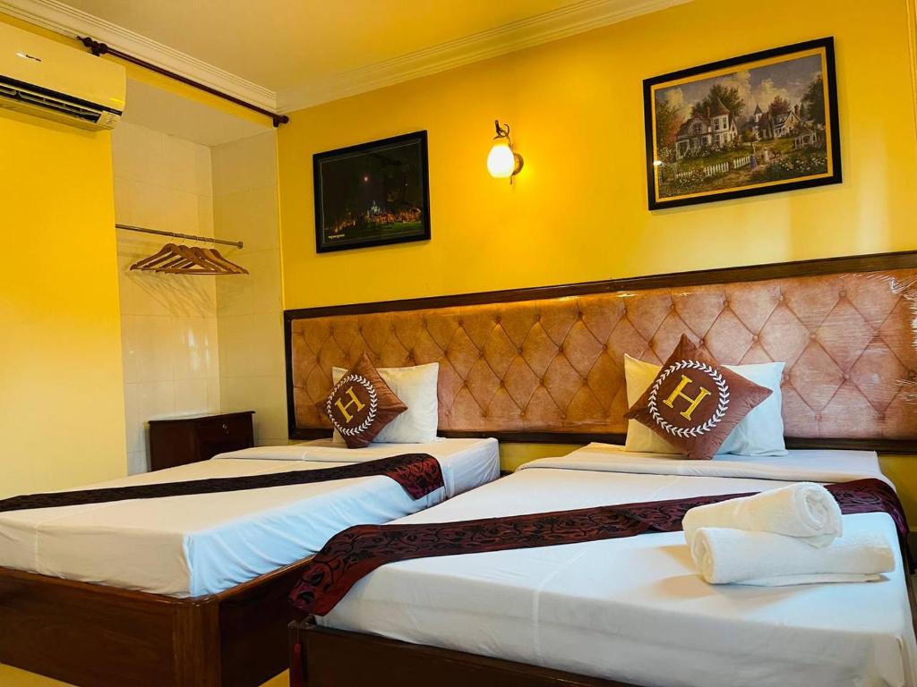 Postel nebo postele na pokoji v ubytování Spean Meas Hotel