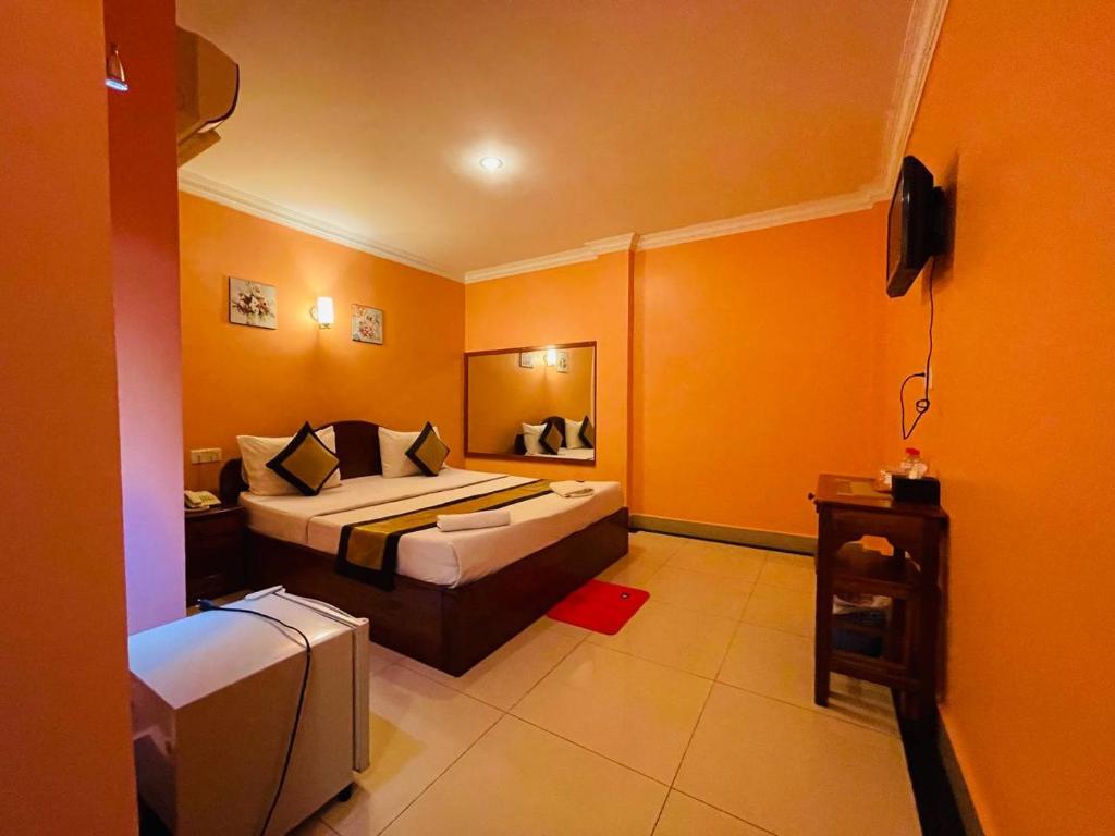 Postel nebo postele na pokoji v ubytování Spean Meas Hotel