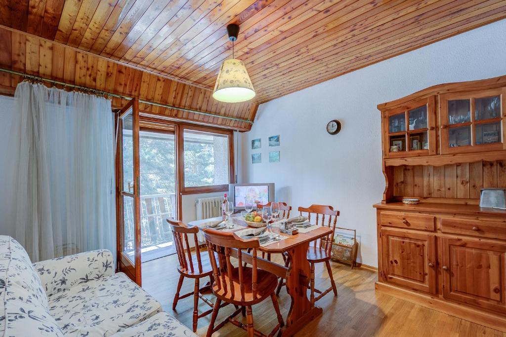 a dining room with a table and chairs at La Tana dello Scoiattolo Skiing nearby - Happy Rentals in Bardonecchia