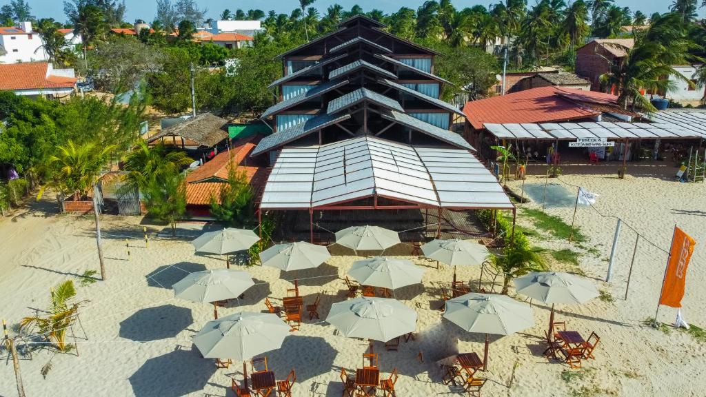 an overhead view of a building with umbrellas on the beach at Casa Flor de Sal in Camocim