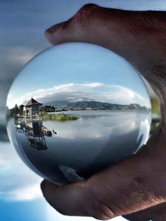 a person holding a glass ball in their face at Villa Luminosa in Torre del Lago Puccini