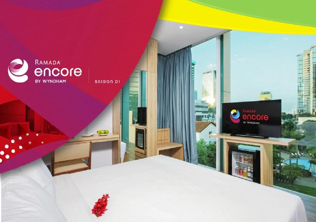 a bedroom with a bed and a tv in a room at RAMADA ENCORE BY WYNDHAM SAIGON D1 - Formerly M Boutique Hotel Saigon in Ho Chi Minh City