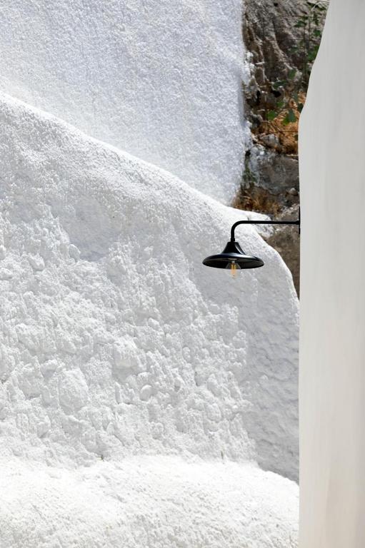 a street light on top of a snow covered slope at Acave Santorini Suites in Vóthon