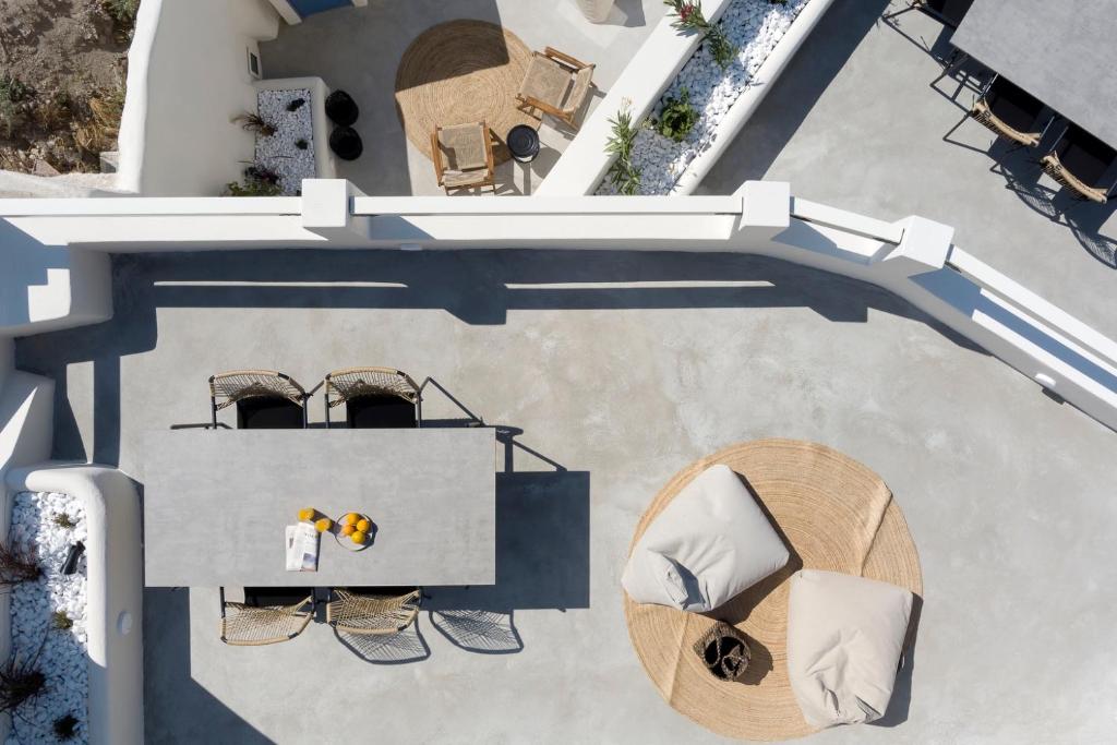 an overhead view of a building with a table and chairs at Acave Santorini Suites in Vóthon