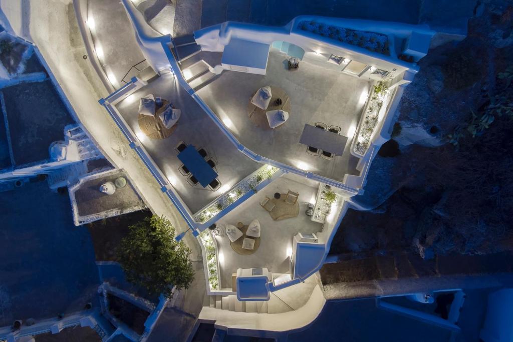an overhead view of a building with a parking lot at Acave Santorini Suites in Vóthon