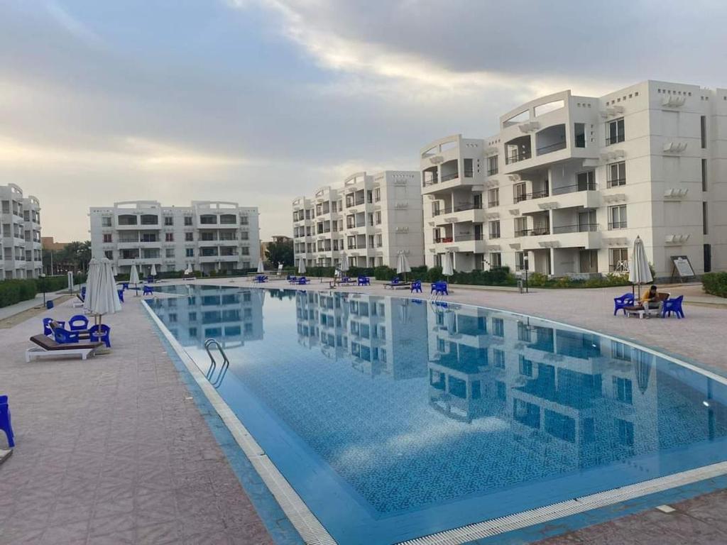 a large swimming pool in front of some apartment buildings at palmera el sokhna in Suez