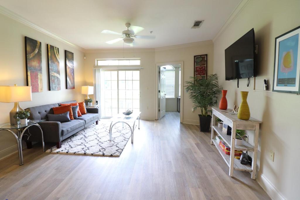 a living room with a couch and a tv at 1 BR 1BA Oasis Near LSU and Casino Free Parking in Baton Rouge