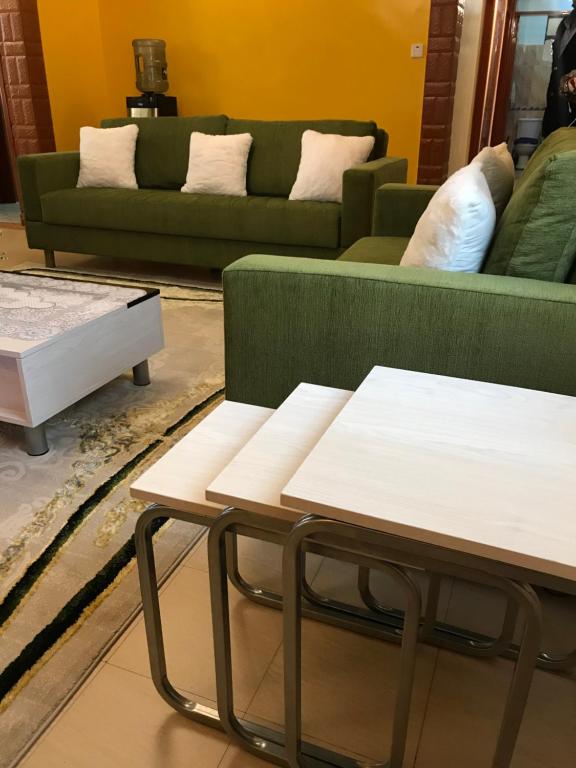 a living room with a couch and a coffee table at Maliaways Comfy Airbnb-Jkia in Nairobi