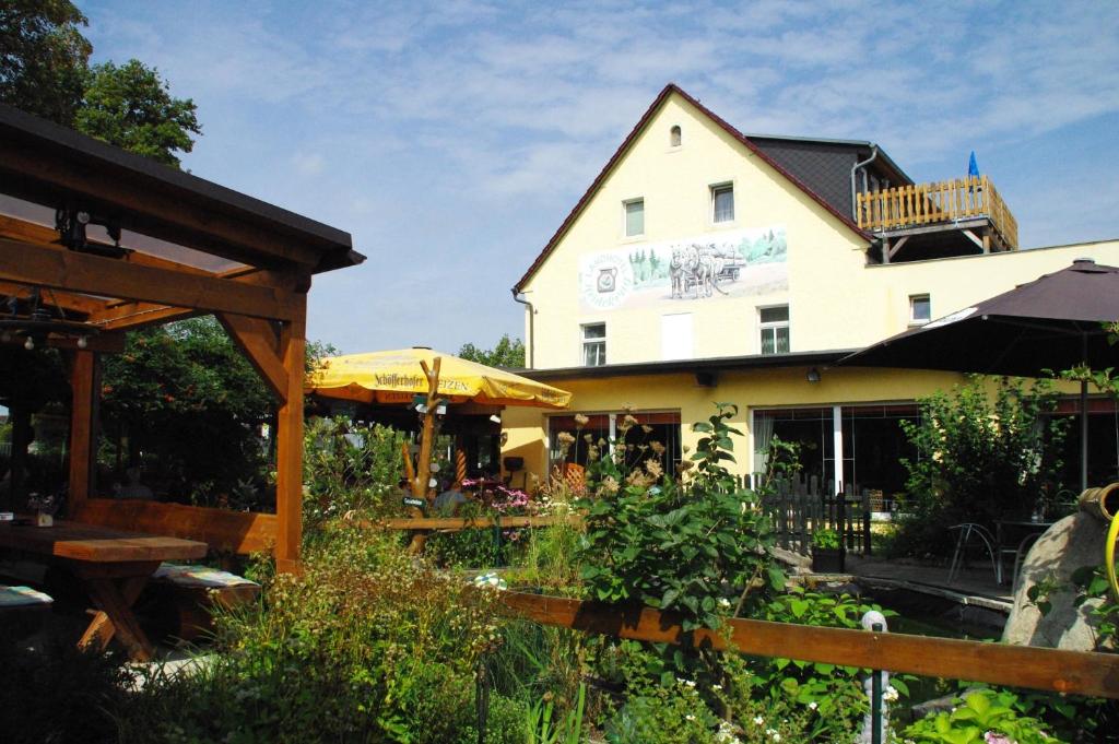 un edificio con un jardín delante de él en Landhotel Heidekrug en Dohma