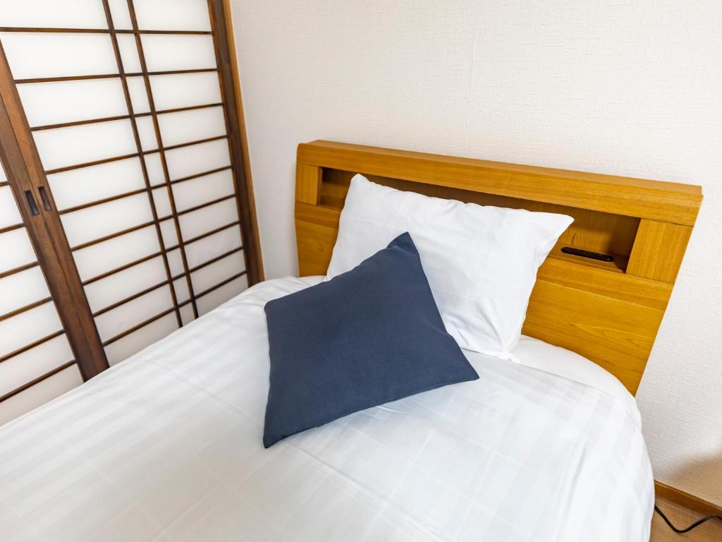 Postel nebo postele na pokoji v ubytování Tabist Hotel Aihama Beppu