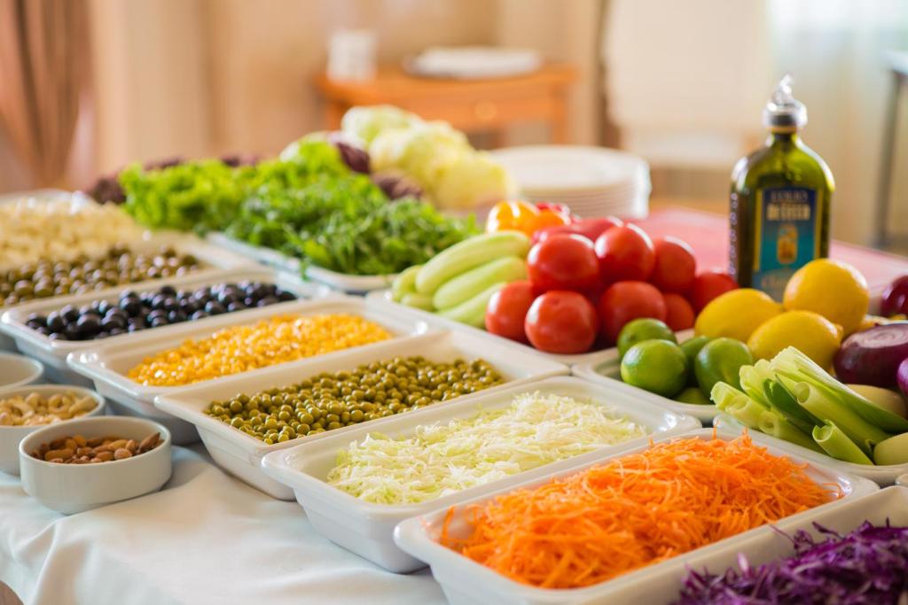 a table topped with trays of different types of vegetables at Rixos-Prykarpattya Resort in Truskavets