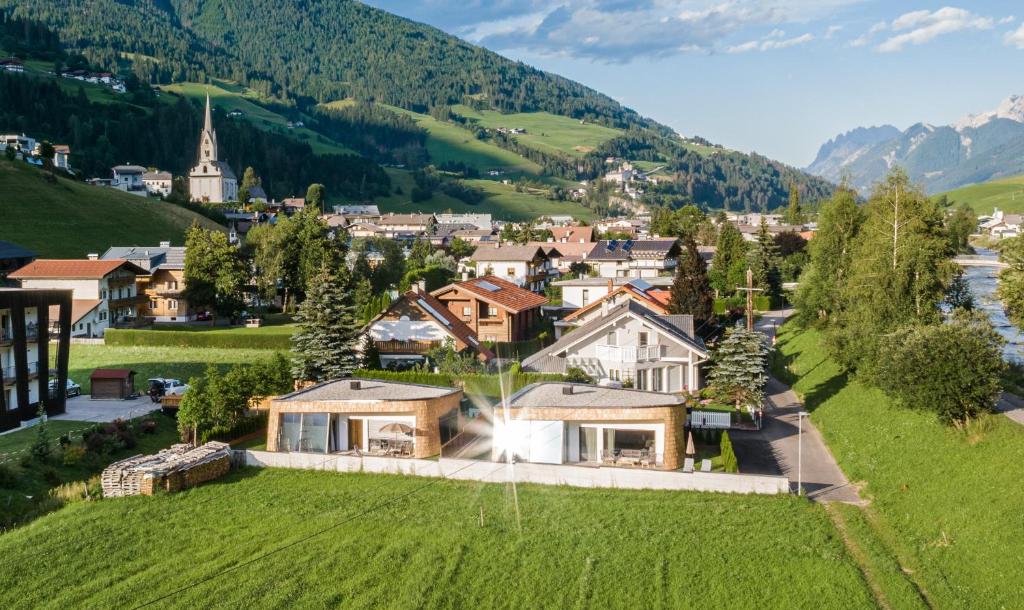 an estate in the mountains with a green field at Chalets Dolomit Royal in Sillian