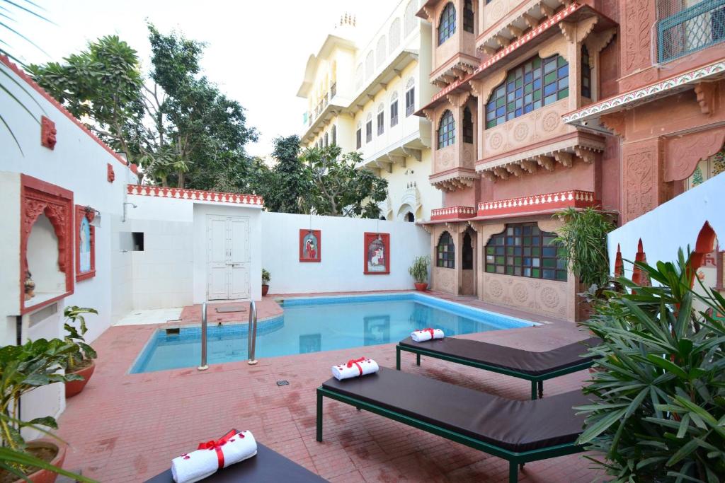 a pool in the courtyard of a building at Mahal Khandela - A Heritage Hotel and Spa in Jaipur