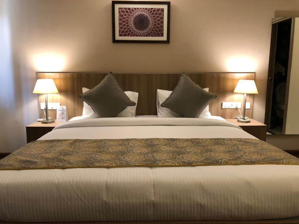 Postel nebo postele na pokoji v ubytování Starlit Suites Tirupati