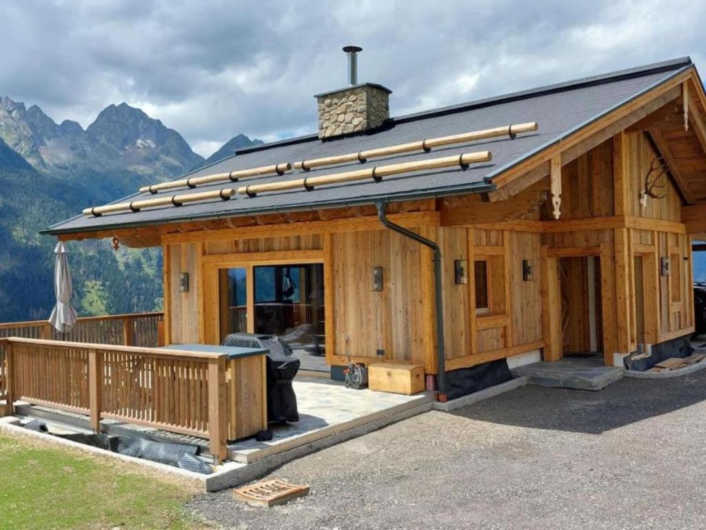 a large wooden house with a roof at Chalet in Großkirchheim Carinthia with sauna in Großkirchheim