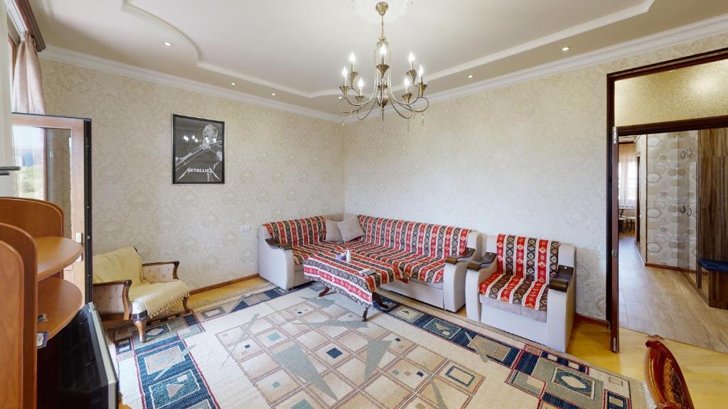 a living room with a couch and a chandelier at Yerevan City Center apartment in Yerevan
