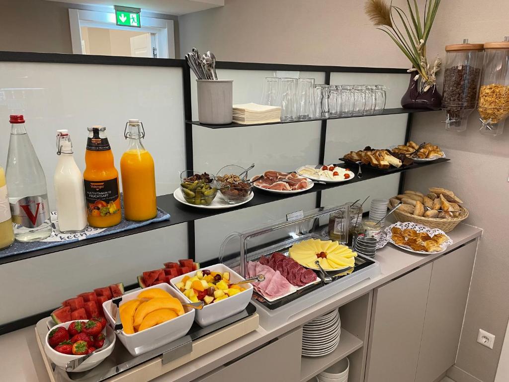a buffet with many plates of food and drinks at Hotel Monvillage in Mondercange