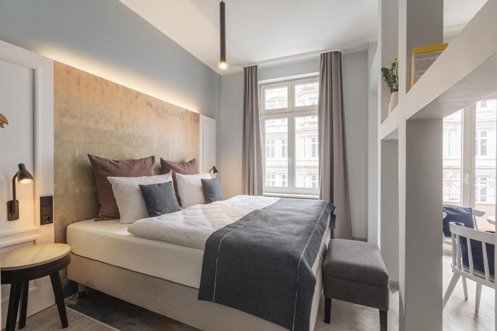 a bedroom with a large bed and a window at acora City Apart Living the City in Hamburg