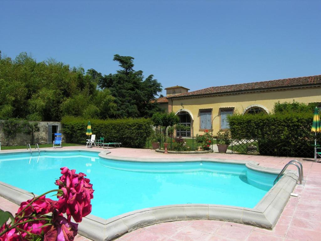 a large swimming pool in front of a house at Villa Senni in Scarperia