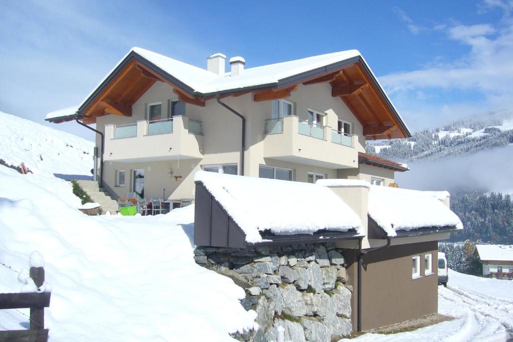 a house in the snow with snow at Appartement Jäger Manuela in Flachau