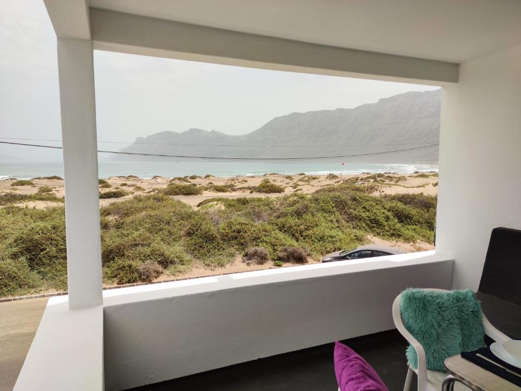 a room with a window view of the beach at Beach View House in Famara