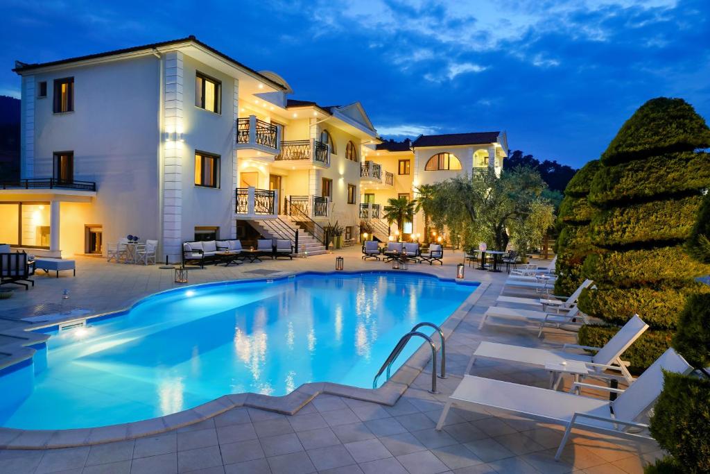 a villa with a swimming pool at night at Maryan in Limenas