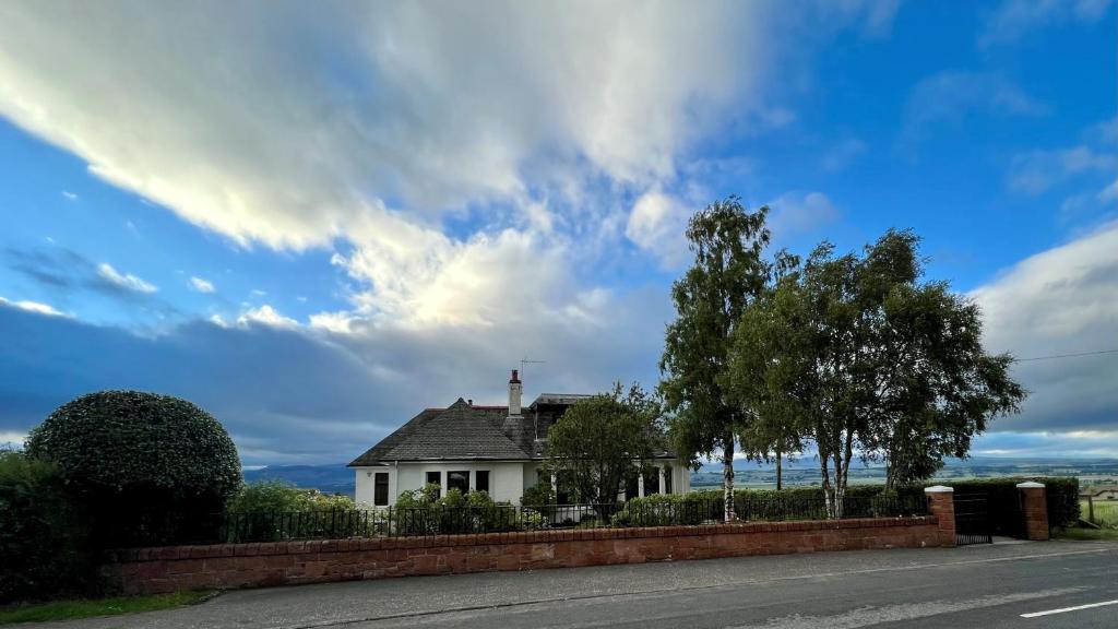 a white house on the side of a road at St Michael's in Kippen