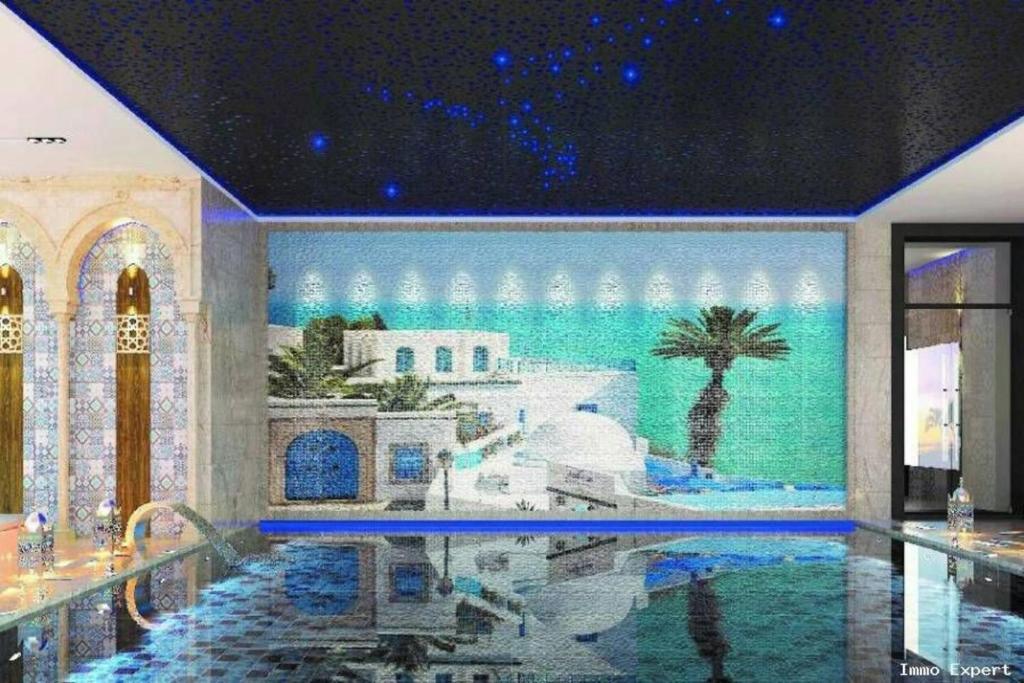 a swimming pool in a building with a painting on the wall at Charming 1-Bed Apartment in Tunis close to centre in Tunis