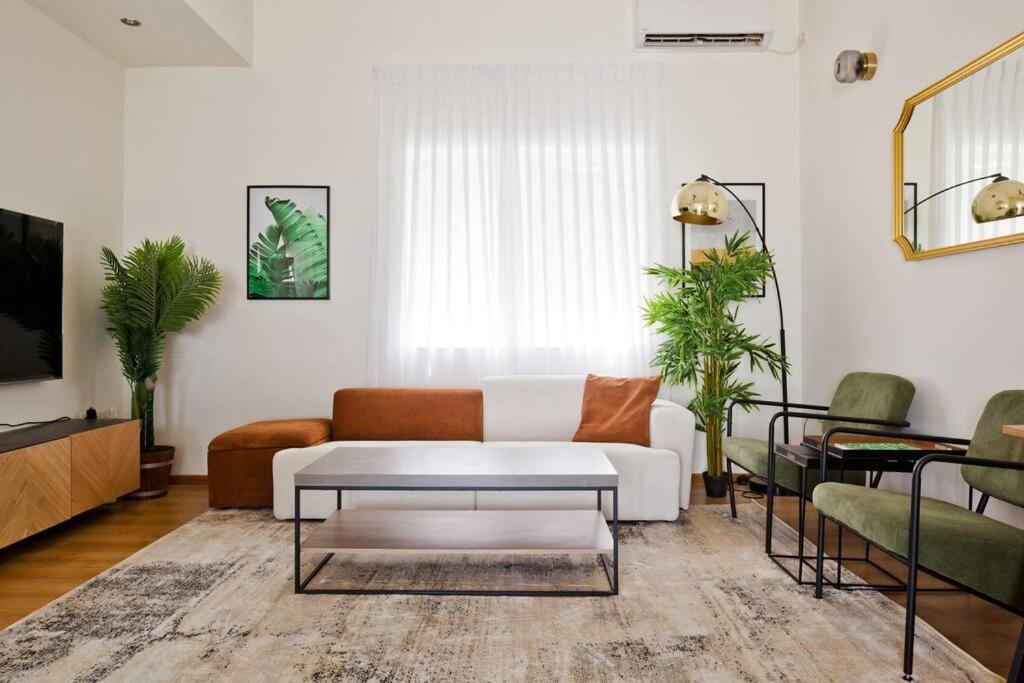 a living room with a couch and a coffee table at ^Superior 1 BR in the heart of the old north^ in Tel Aviv