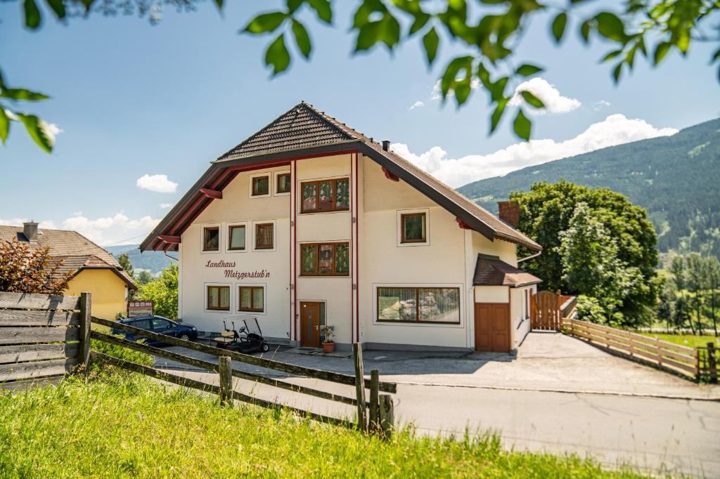 a house with a fence in front of it at Landhaus Metzgerstubn in Sankt Martin