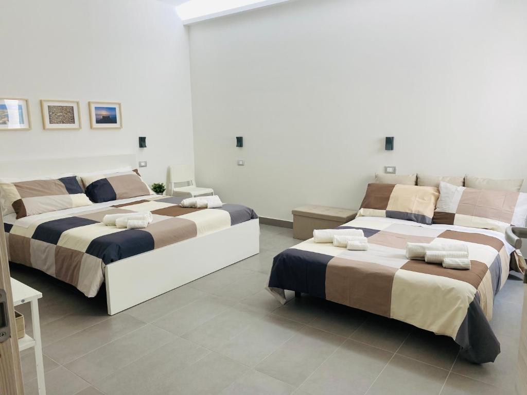 Postel nebo postele na pokoji v ubytování Sicilian Rooms