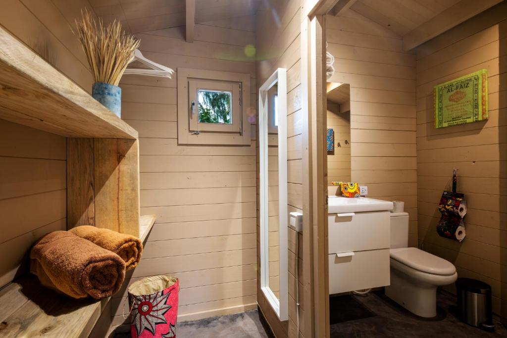 a small bathroom with a toilet and a sink at Mwezi Boutique Resort in Jambiani