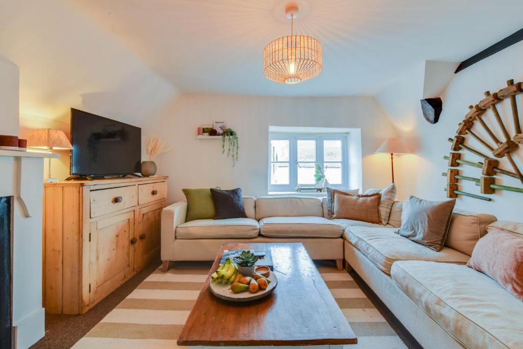 a living room with a couch and a table at The Nook, Newly Available Relaxed 2 bed, Cotswolds in South Cerney